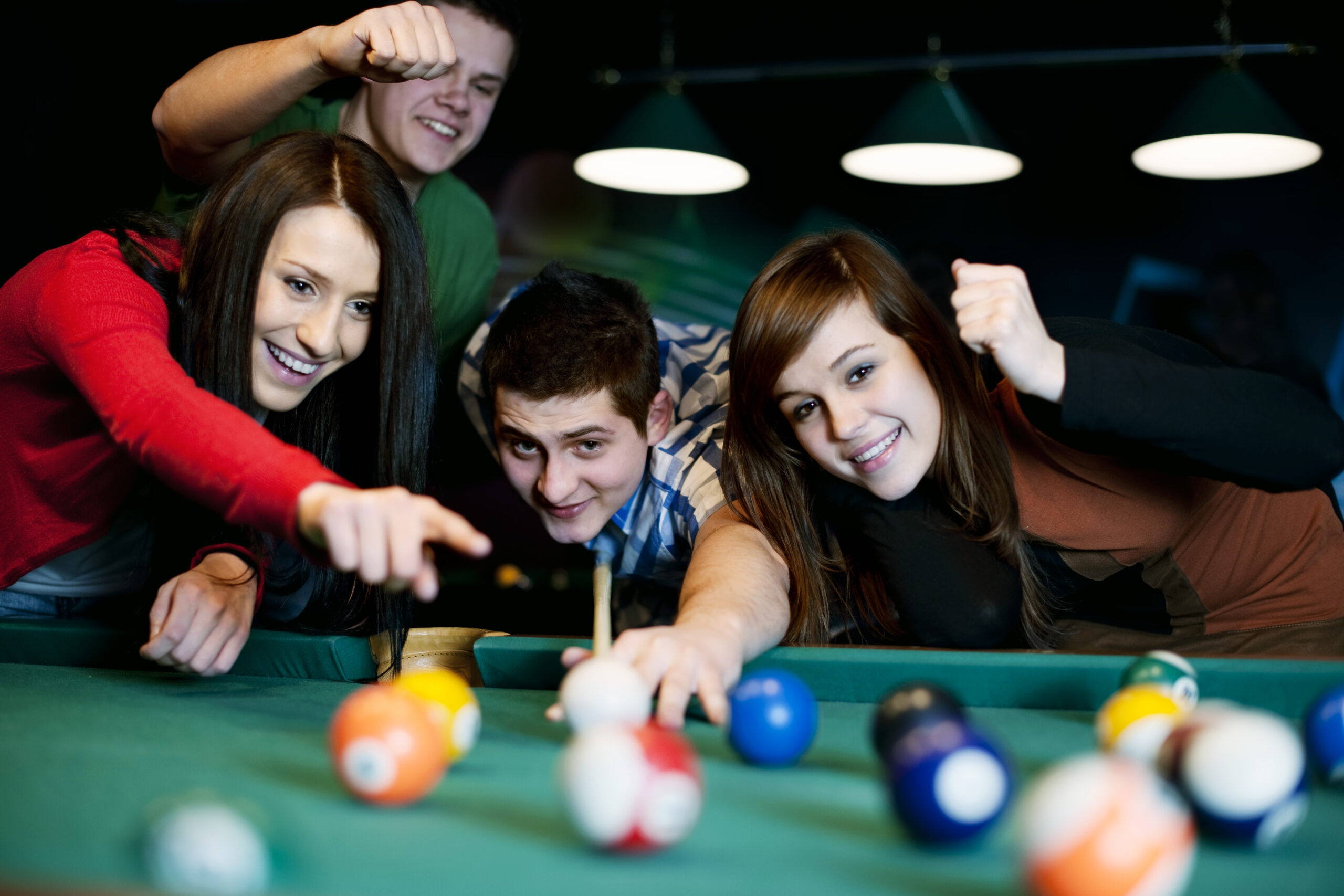 Friends playing billiard